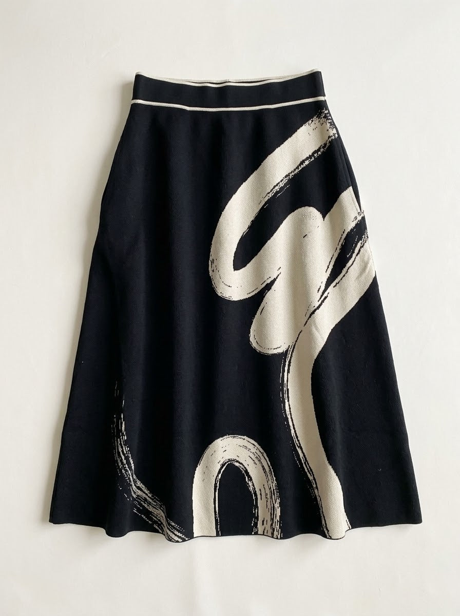 Front view of the Hilda black A-line skirt showing its bold cream print