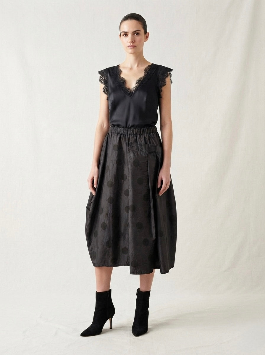 Model wearing the Brooke black spot taffeta skirt with ankle boots