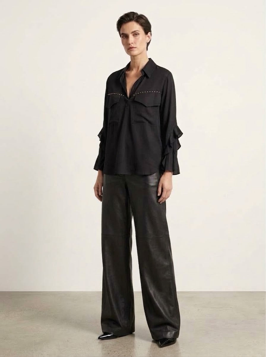 Model wearing the Fredi black wide leg pleather jeans