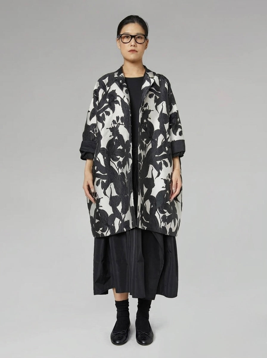 Model wearing the Delani floral cocoon coat open, front view
