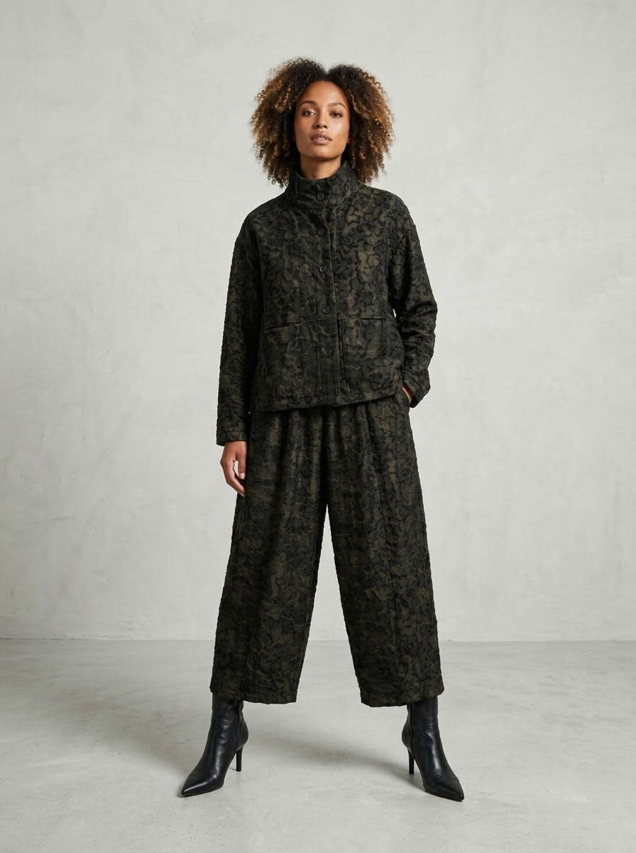 Model wearing bronze Pebbles printed jacket and crop trousers, front view