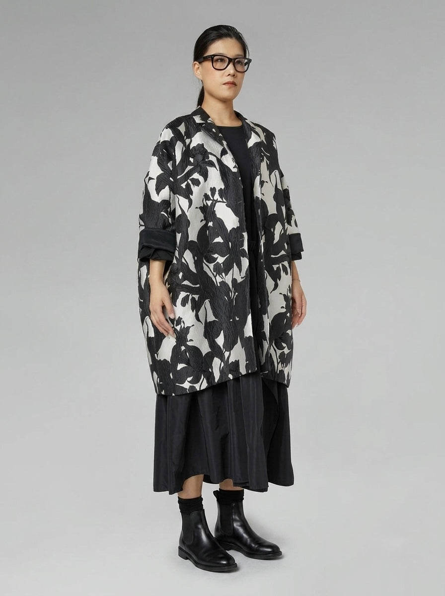 Model wearing the Delani black floral cocoon coat, three-quarter view