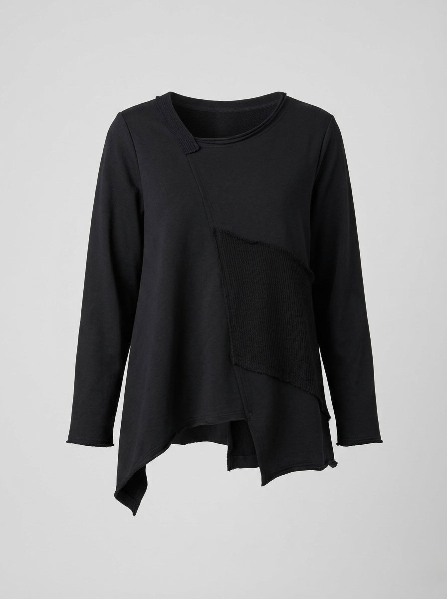 Matilda black mixed-fabric top showing asymmetric patchwork and hem, product view