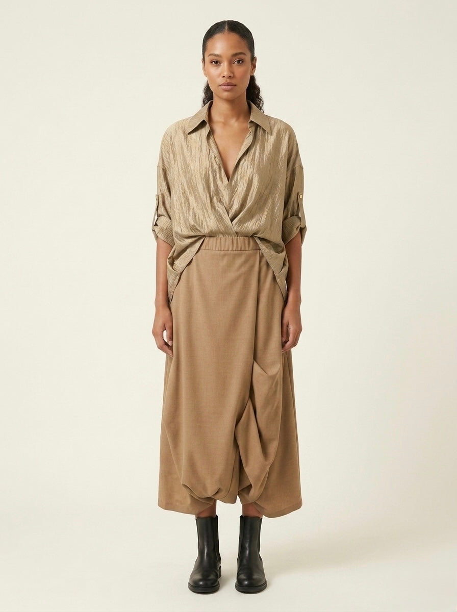 Model wearing the Roberta camel harem trousers with a gold shirt, front view