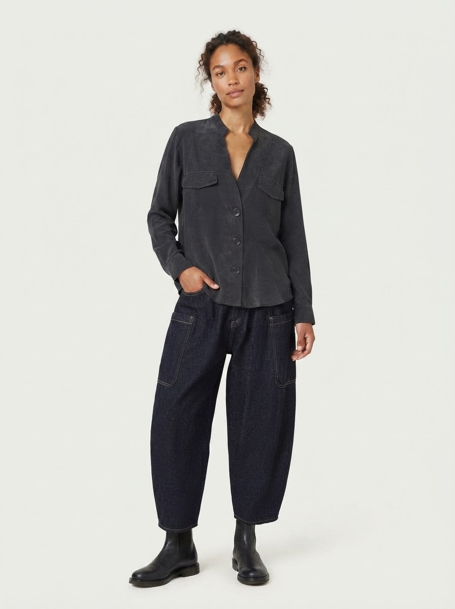 Model wearing black Rosie pocket flap blouse with denim trousers