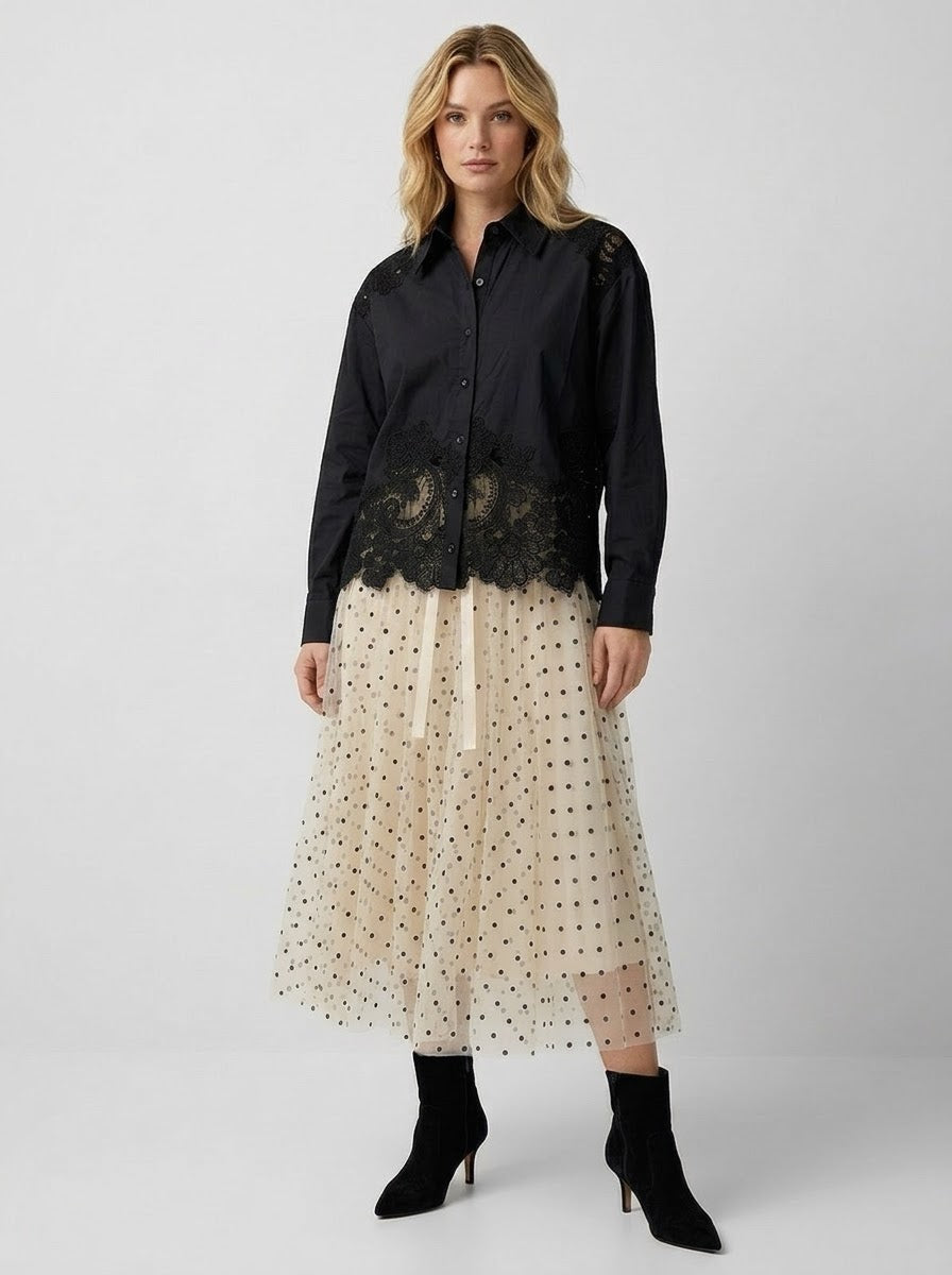 Model wearing black Faye lace trim shirt with cream tulle skirt