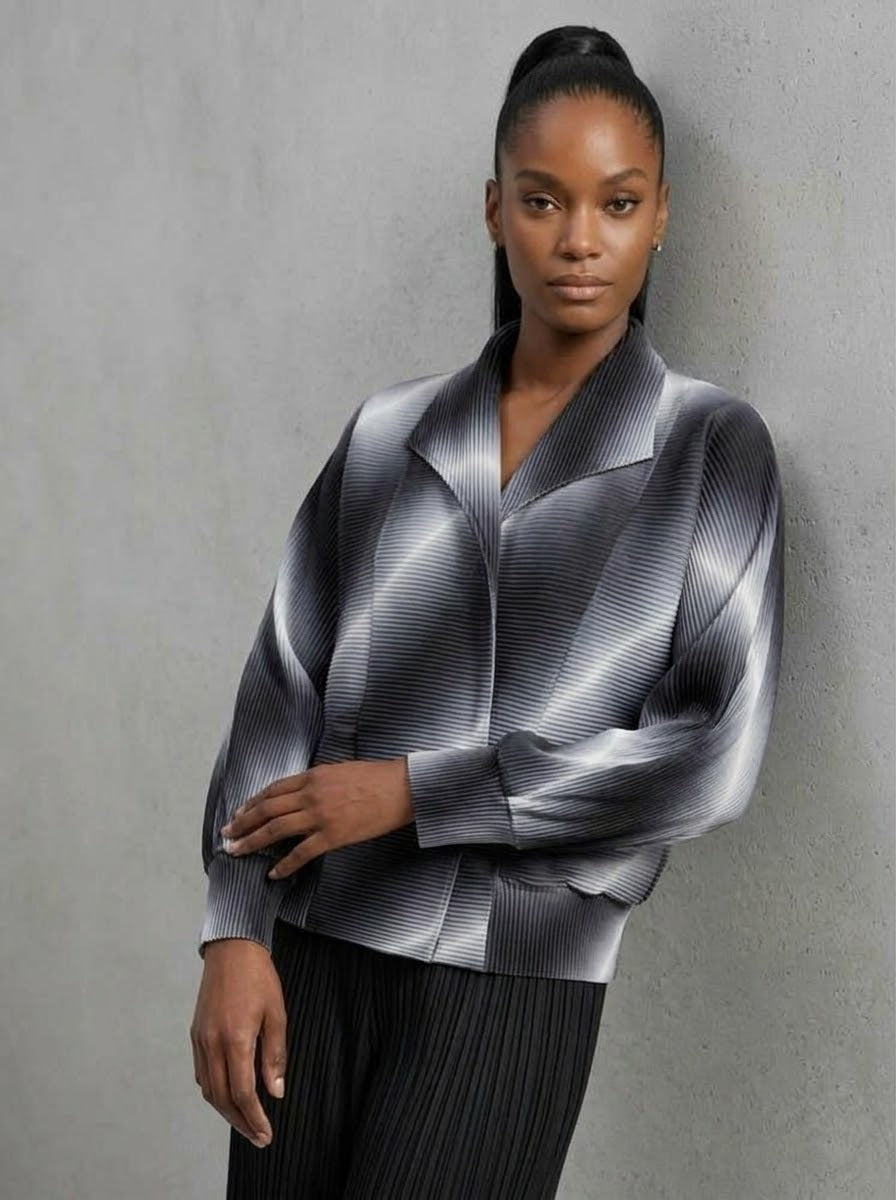 Close-up of model wearing grey Juliette pleated bomber jacket