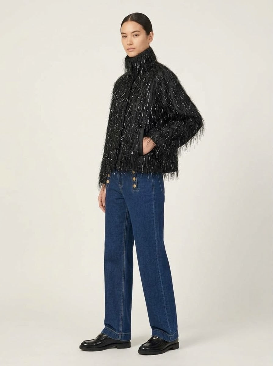 Model wearing Scarlett fringed chiffon jacket in black, side view