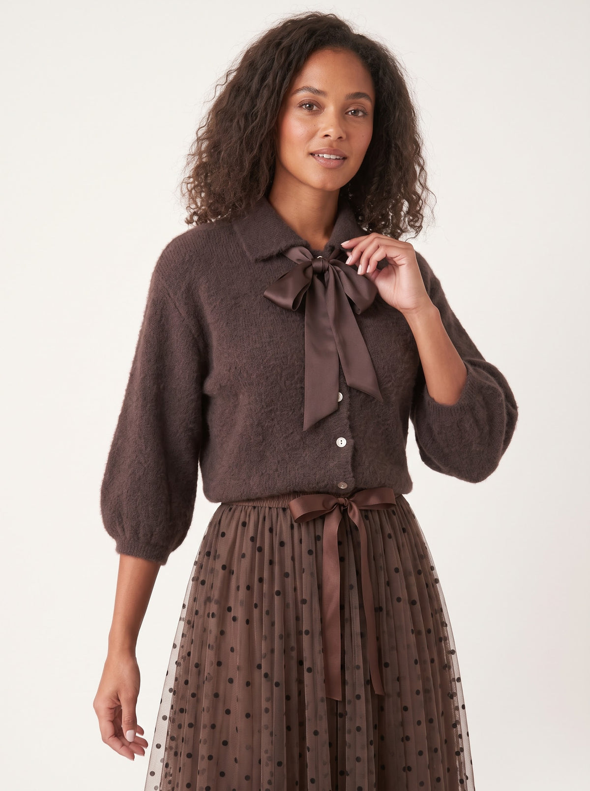 Model wearing the Antoinette chocolate angora-blend cardigan with detachable satin bow