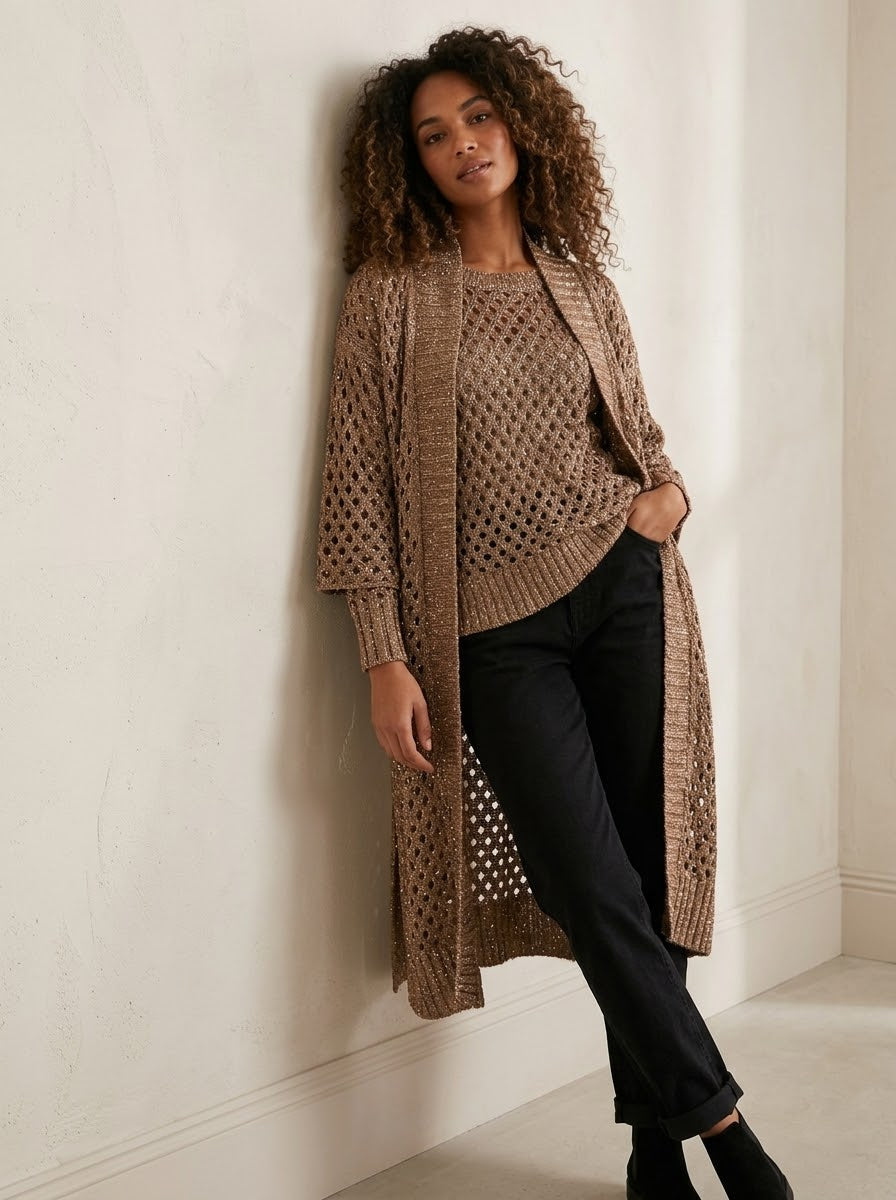 Model wearing the Barbados bronze long crochet cardigan with black trousers