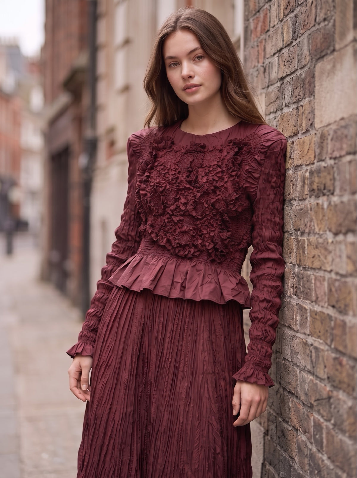 Model wearing Emma burgundy Confetti Top, showing the raised front texture, round neckline and flared hem.