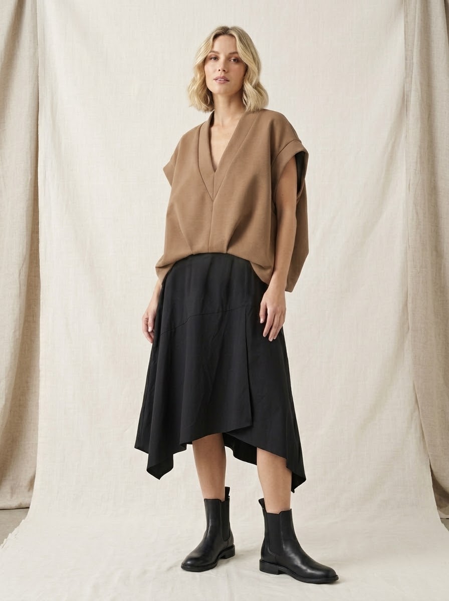 Model wearing camel Bronte scuba top with black asymmetric skirt