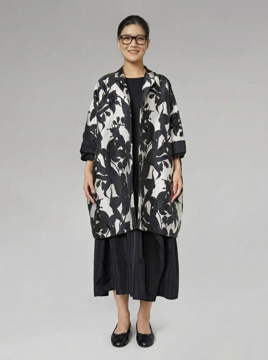 Model wearing the Delani floral cocoon coat buttoned, front view