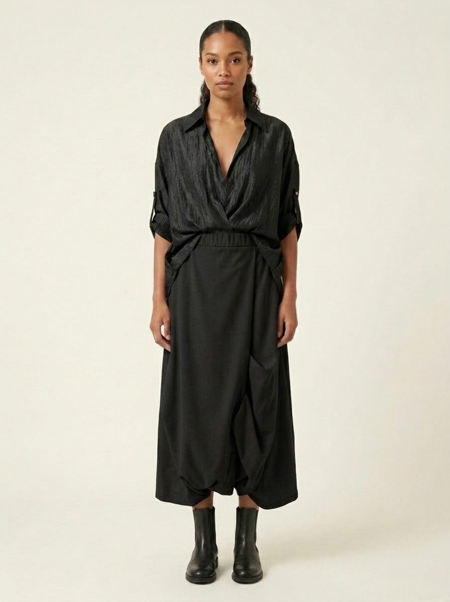Model wearing black Roberta harem trousers with wrap-effect front, full view