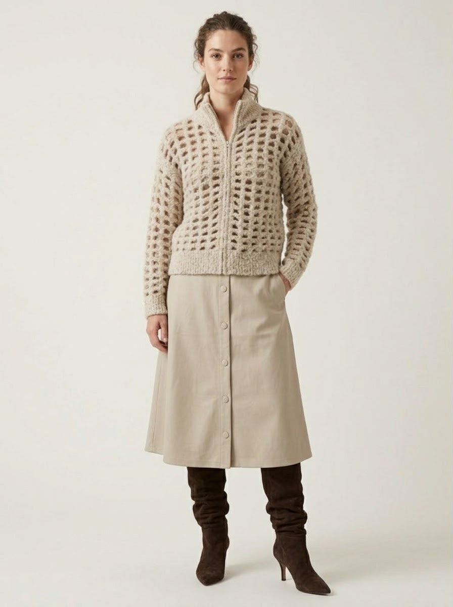 Model wearing the Zoe stone A-line pleather skirt with tall boots