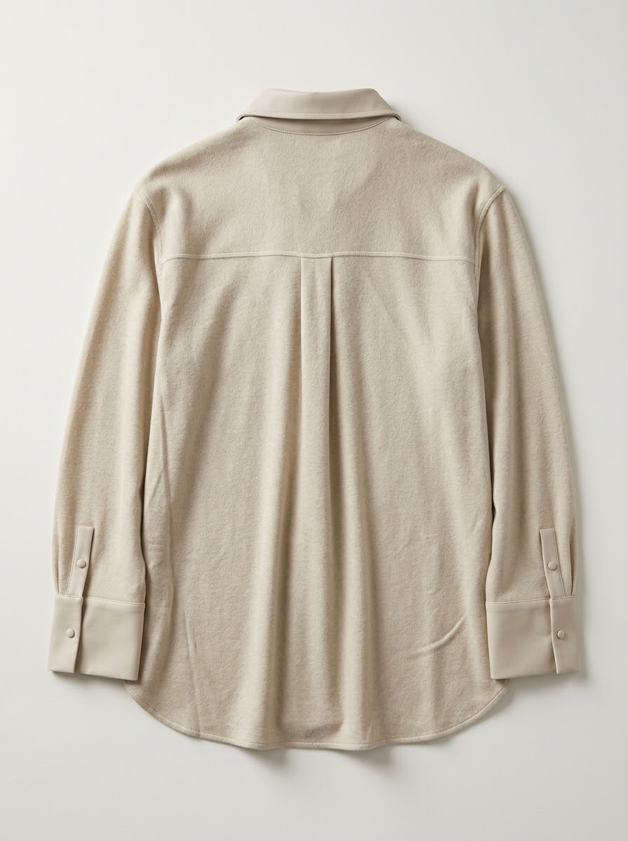 Side view of the Marley stone mixed-fabric shirt showing its curved hem and slit
