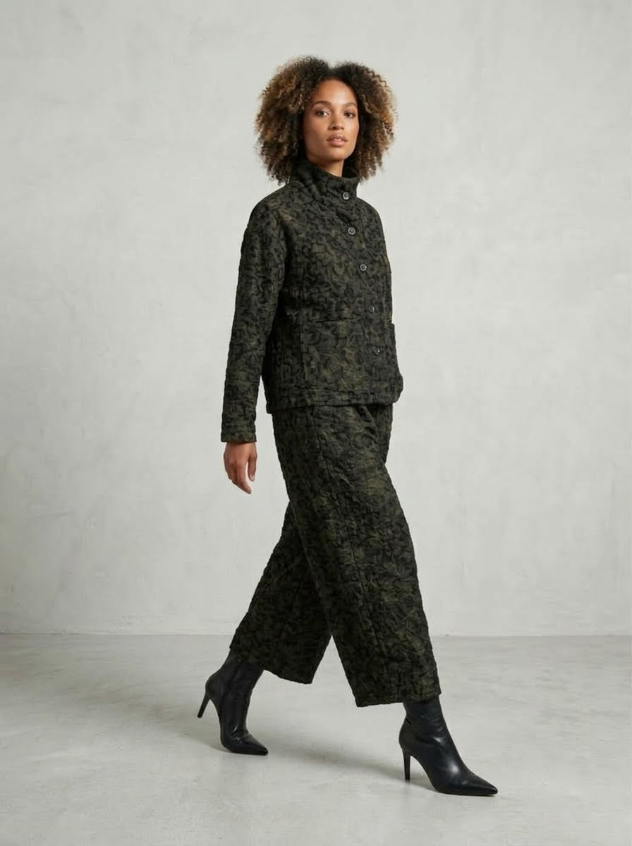 Model walking in bronze Pebbles printed jacket and crop trousers