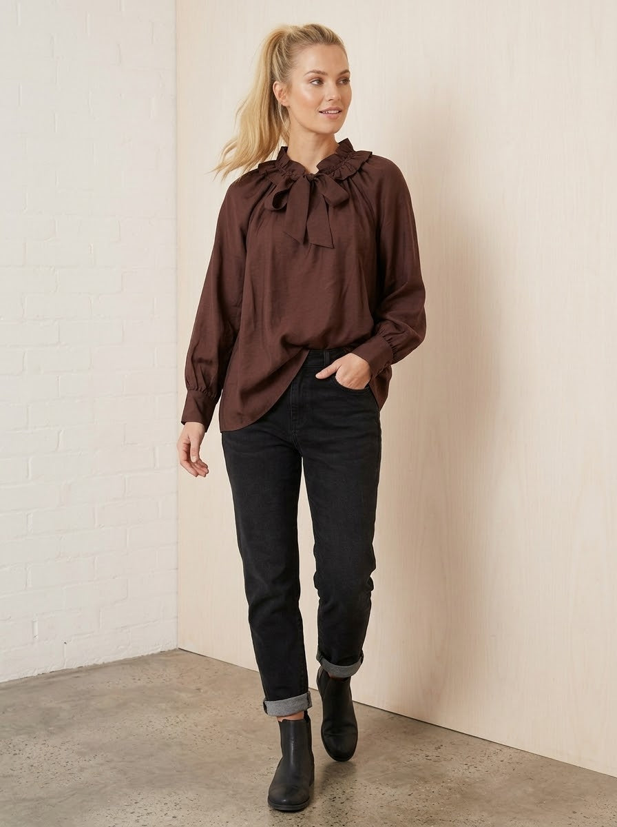 Ariel chocolate frill-neck blouse worn with black jeans