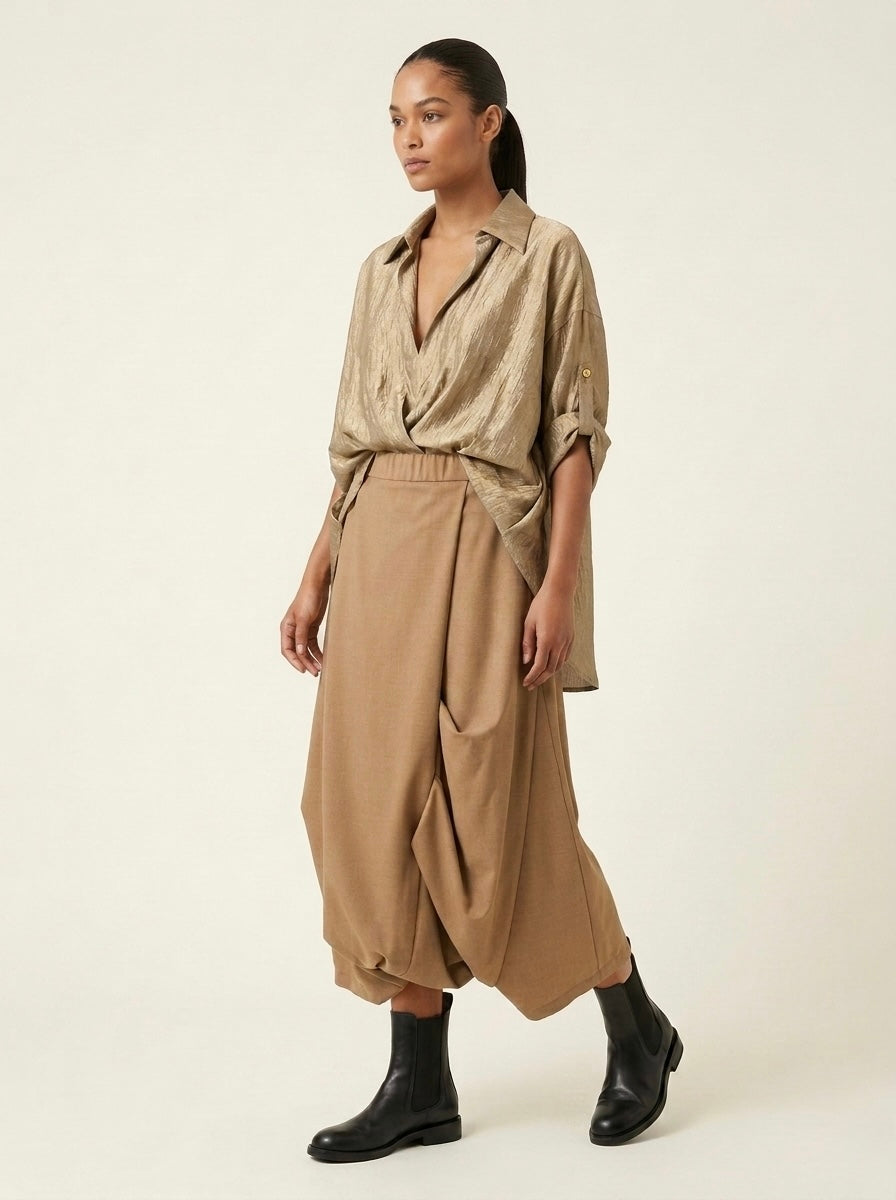 Model wearing the Roberta camel harem trousers, three-quarter view