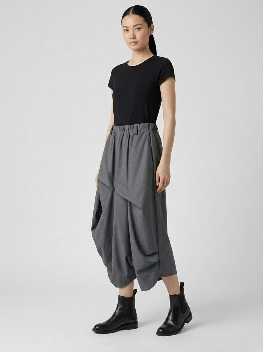 Model wearing the Robbie grey pintuck harem trousers with a black top and boots