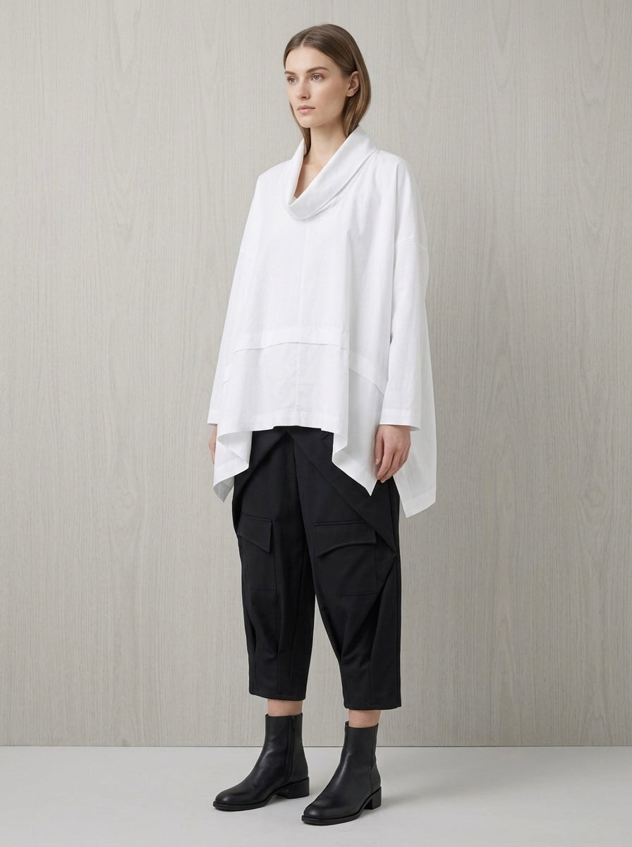 Model wearing white Liv cowl neck top with black cropped trousers, front view