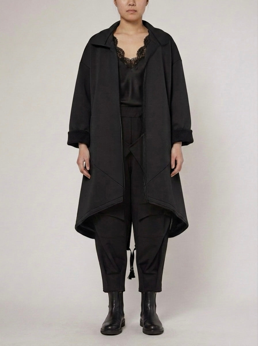Model wearing the Bronte black scuba midi coat, front view