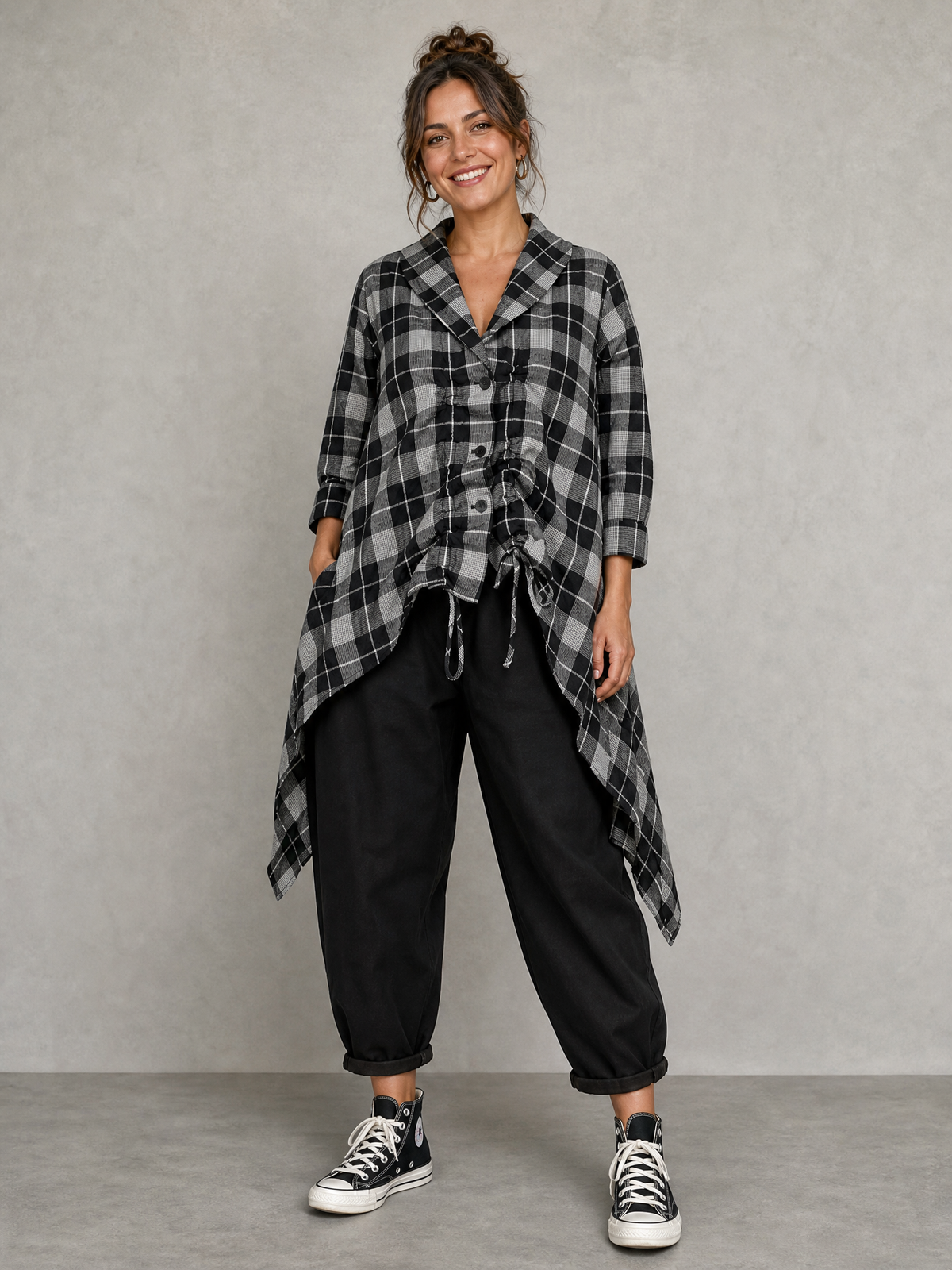 Model wearing Blanche grey check asymmetric shirt with black trousers, front view