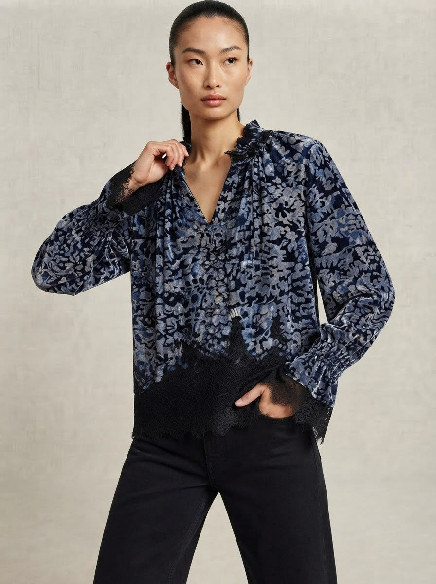 Model wearing Cara devoré lace blouse in grey and black, three-quarter view