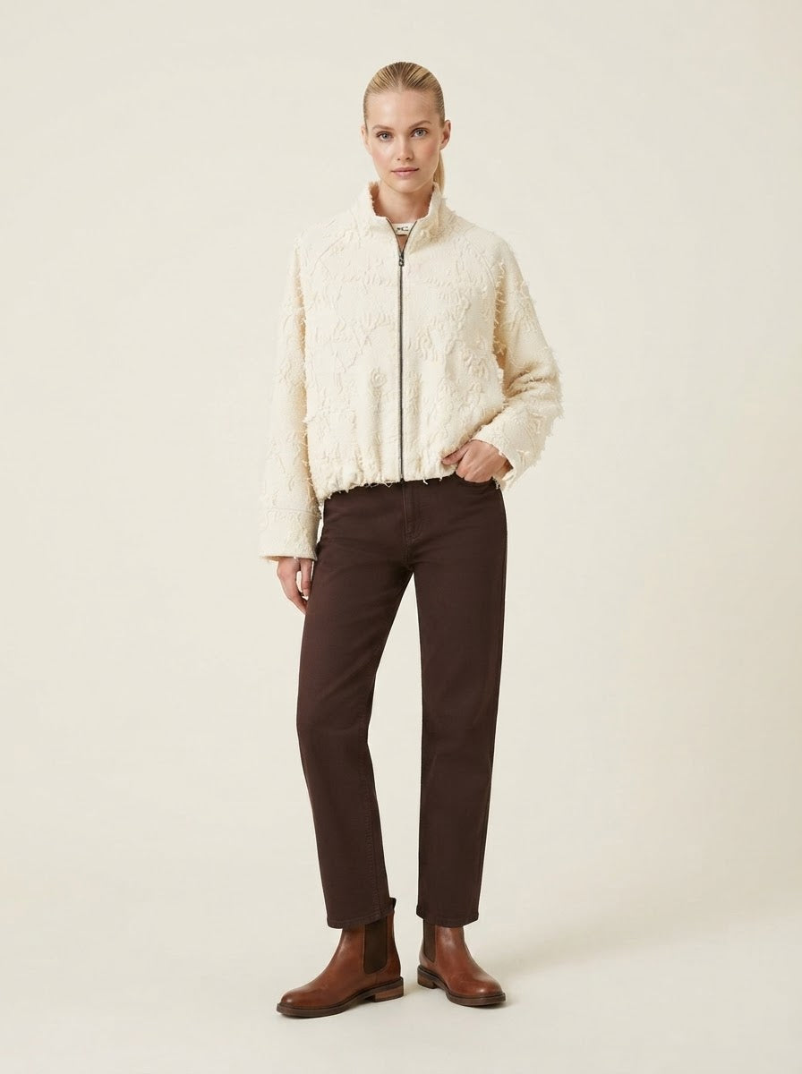 Model wearing cream Sharleen embossed zip jacket, full front view