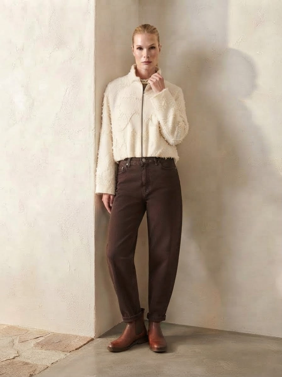 Model wearing Lucia carrot-shape jeans in chocolate, full front view