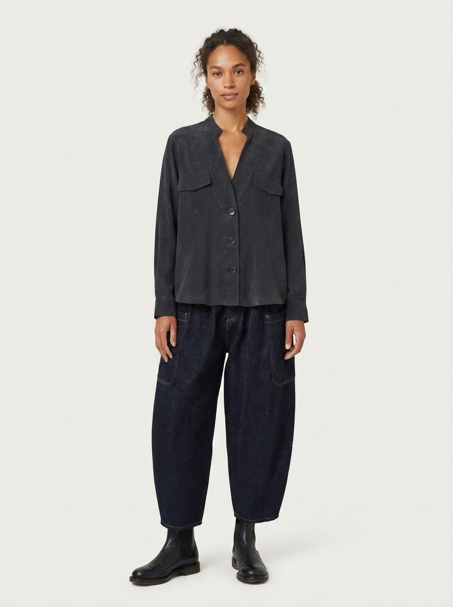 Model wearing Rosie pocket flap blouse in black, front view