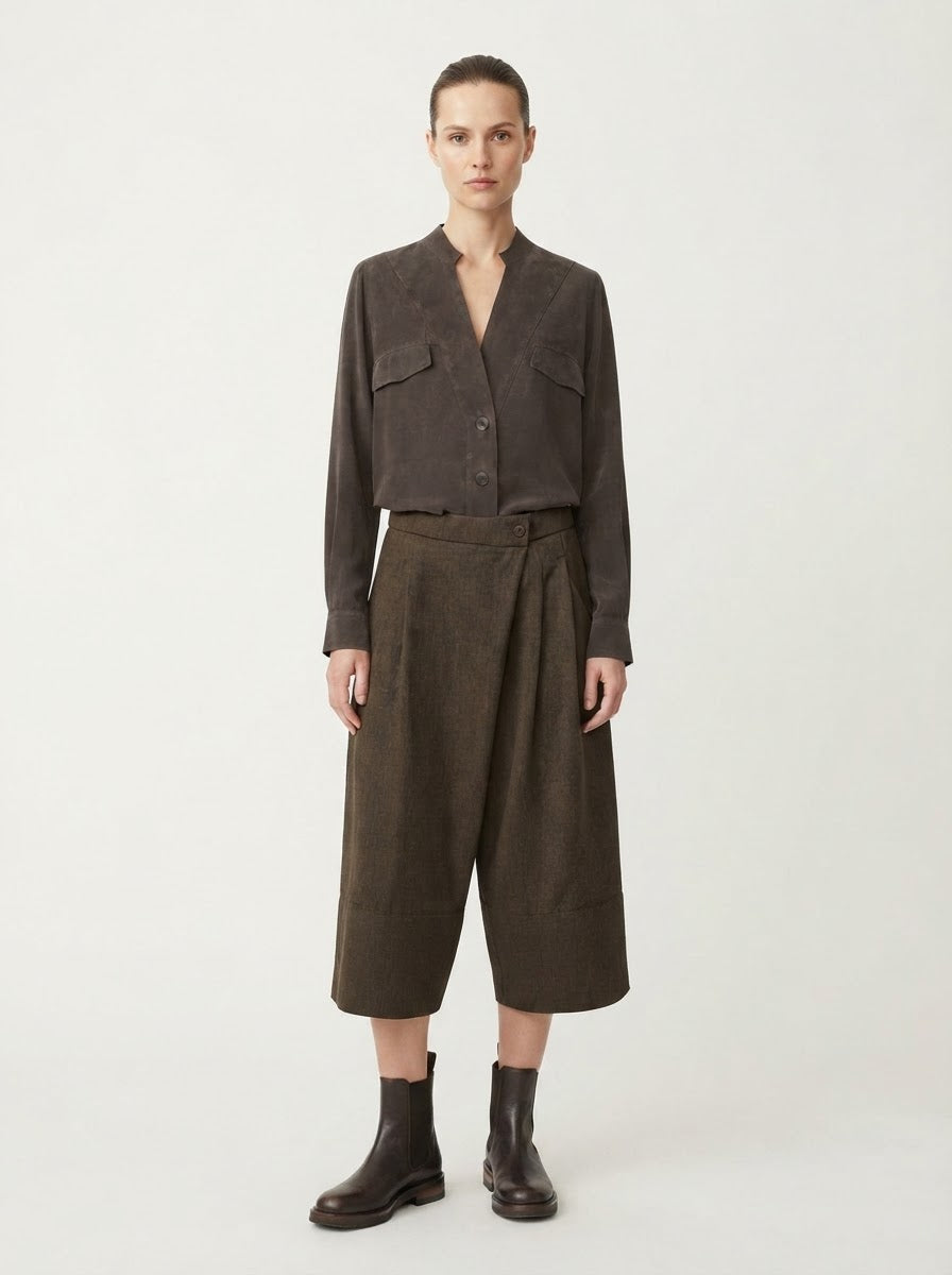 Model wearing chocolate Rosie pocket flap blouse tucked into trousers