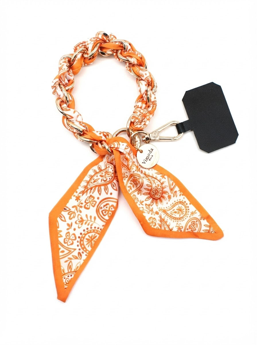 Orange Sandi phone wrist strap with paisley fabric-wrapped gold-tone chain, clasp and phone-case insert tab