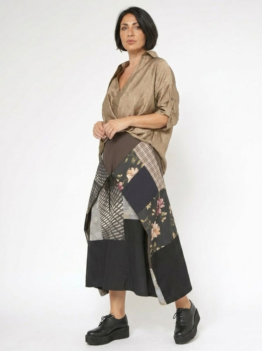 Model wearing Houston patchwork midi skirt in black and neutral tones, side view