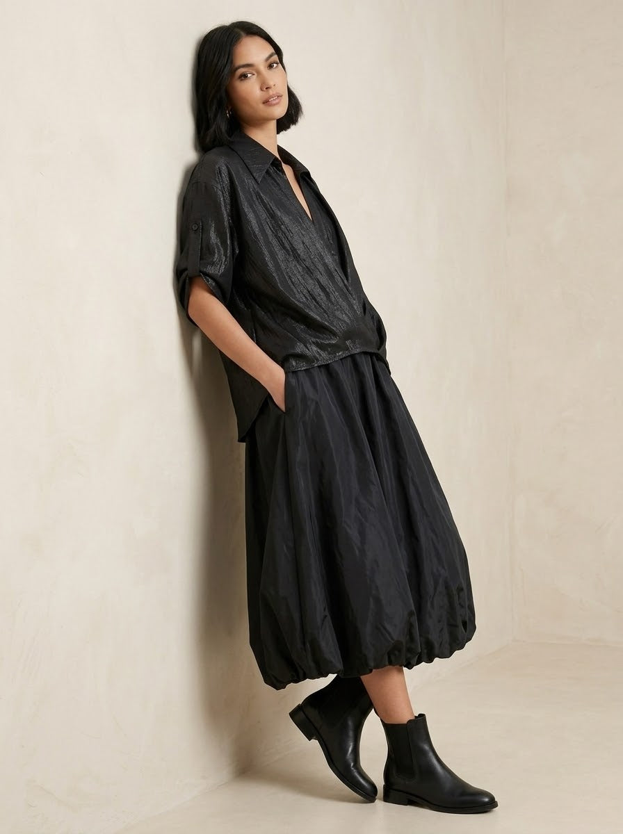 Model wearing black Lavender dipped hem shirt, three-quarter view