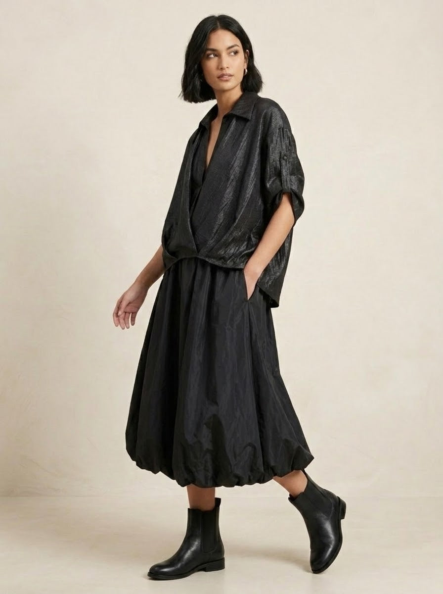 Model wearing black Lavender shimmer shirt with balloon skirt, walking view