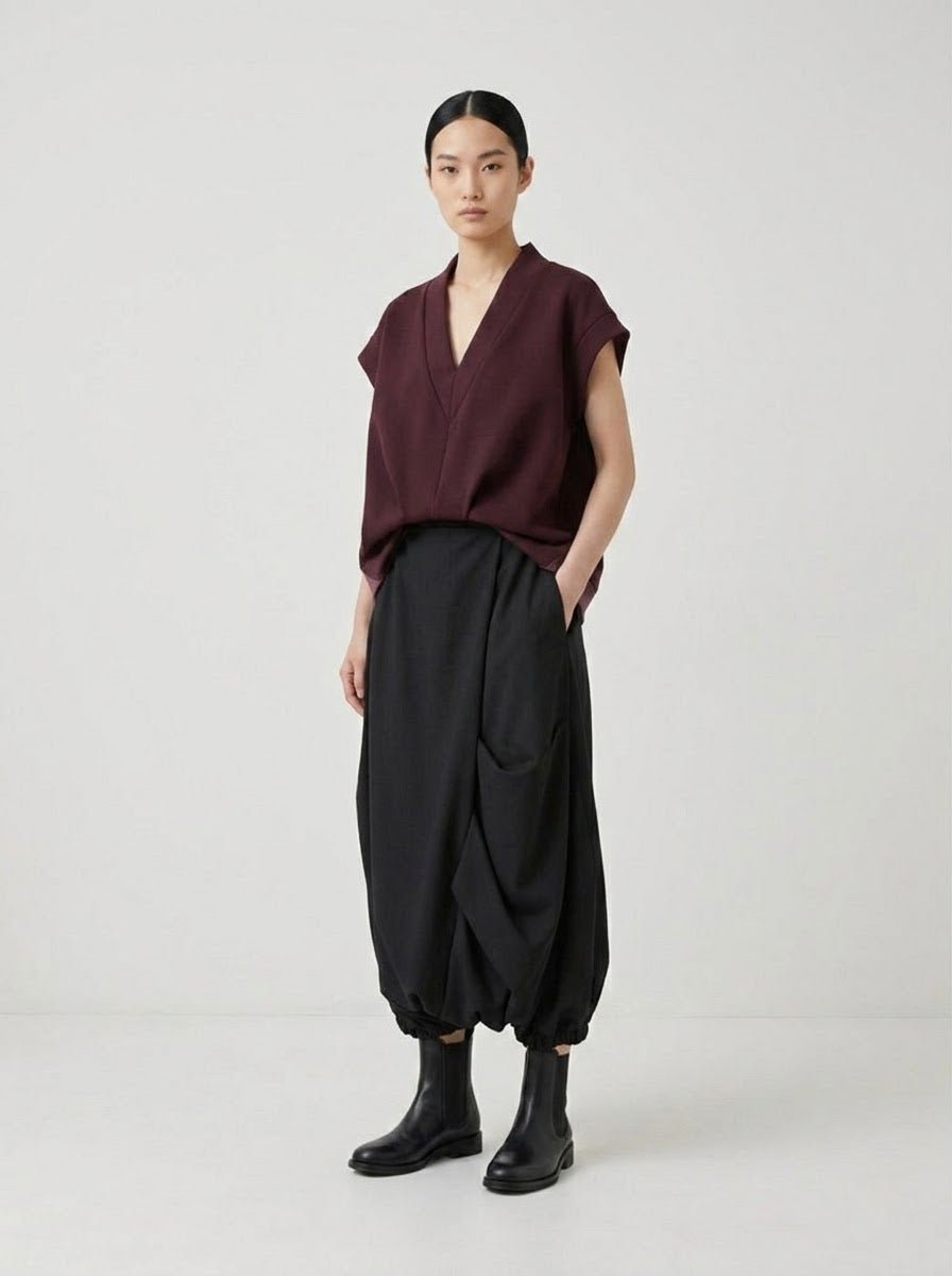 Model wearing burgundy Bronte scuba top with black harem trousers