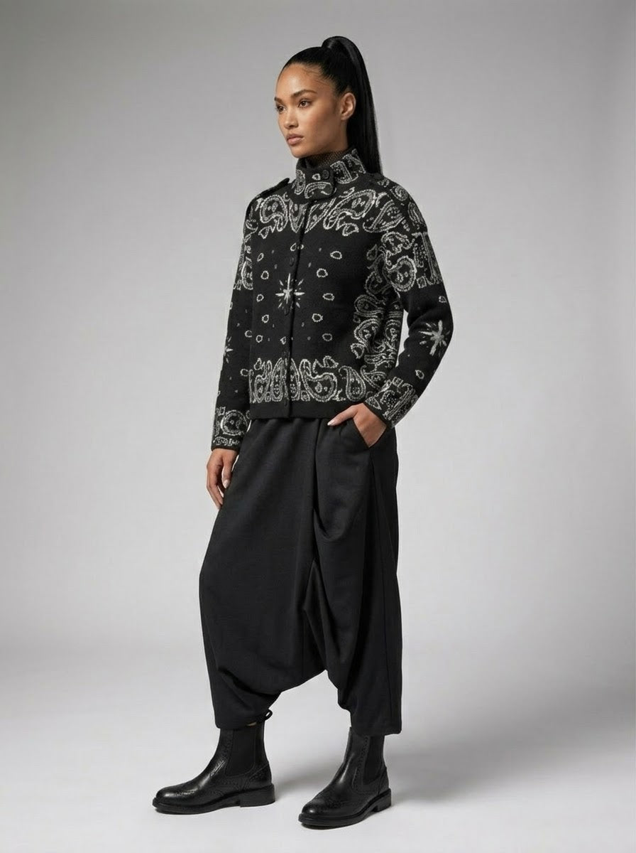 Model wearing Sadie paisley knitted jacket in black, front three-quarter view