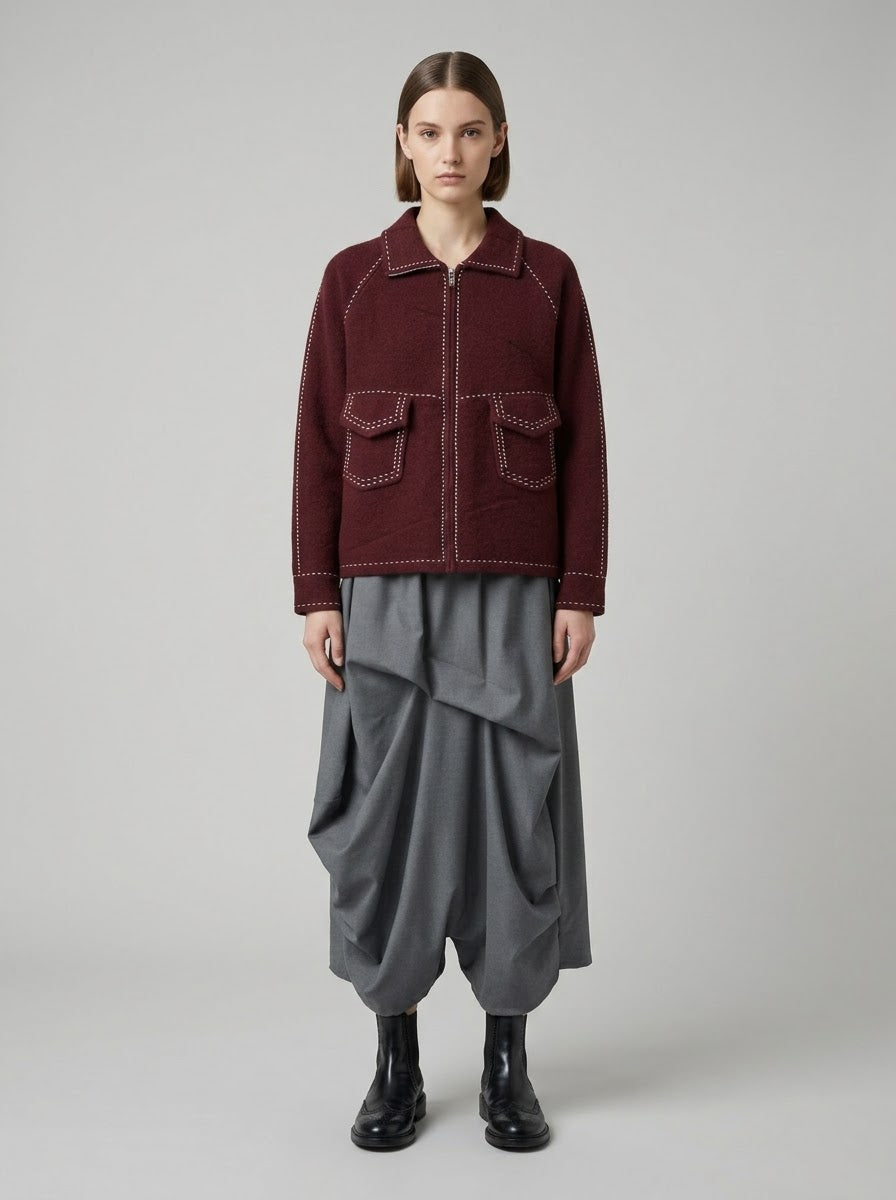 Model wearing Sara saddle stitch knitted jacket in burgundy, full front view