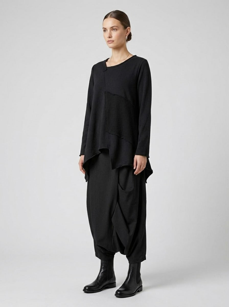 Three-quarter view of the Matilda black asymmetric patchwork top