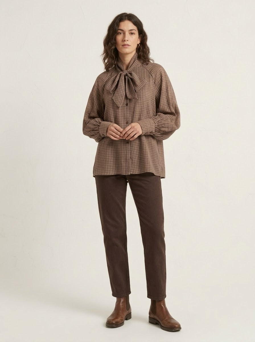 Model wearing Judy checked bow blouse in brown, front view