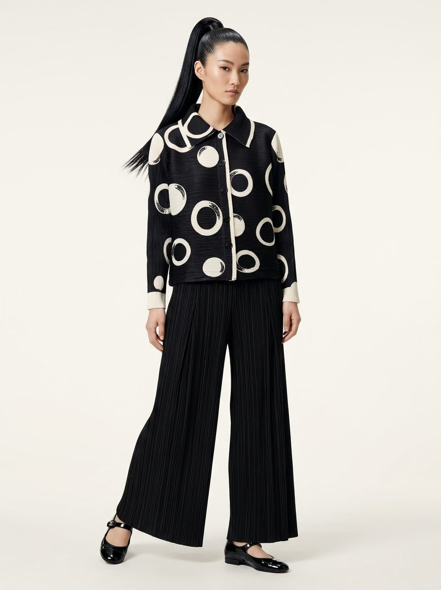 Model wearing Monroe circle print jacket with black Mikaela pleated trousers, front view