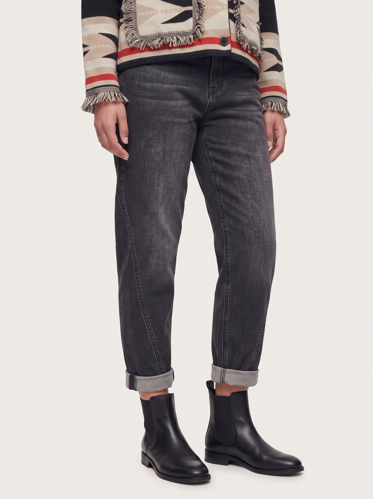 Model wearing the Andra washed black barrel-leg jeans, front detail