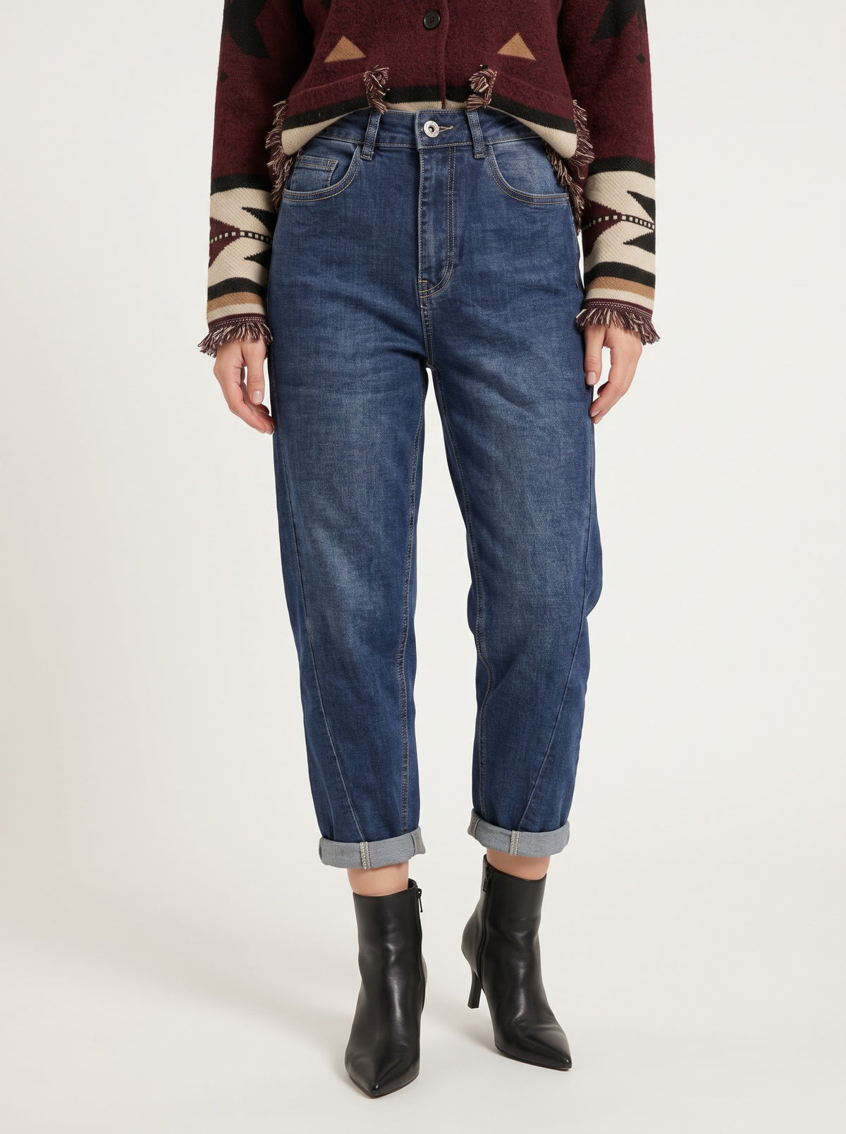 Model wearing the Andra denim blue barrel-leg jeans, front detail