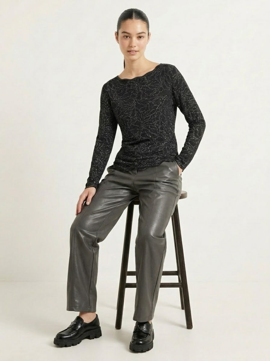 Model wearing the Imani black embossed lurex jumper with grey pleather trousers