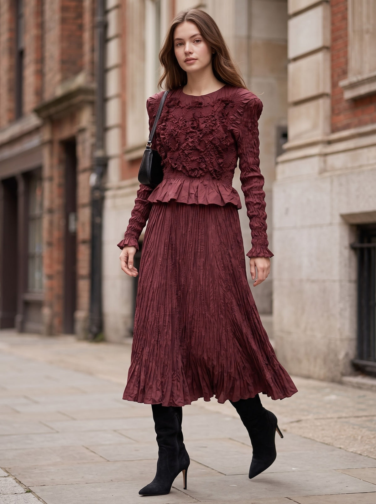 Model walking in Emma burgundy Confetti Top and matching flared crinkle skirt with black heeled boots.