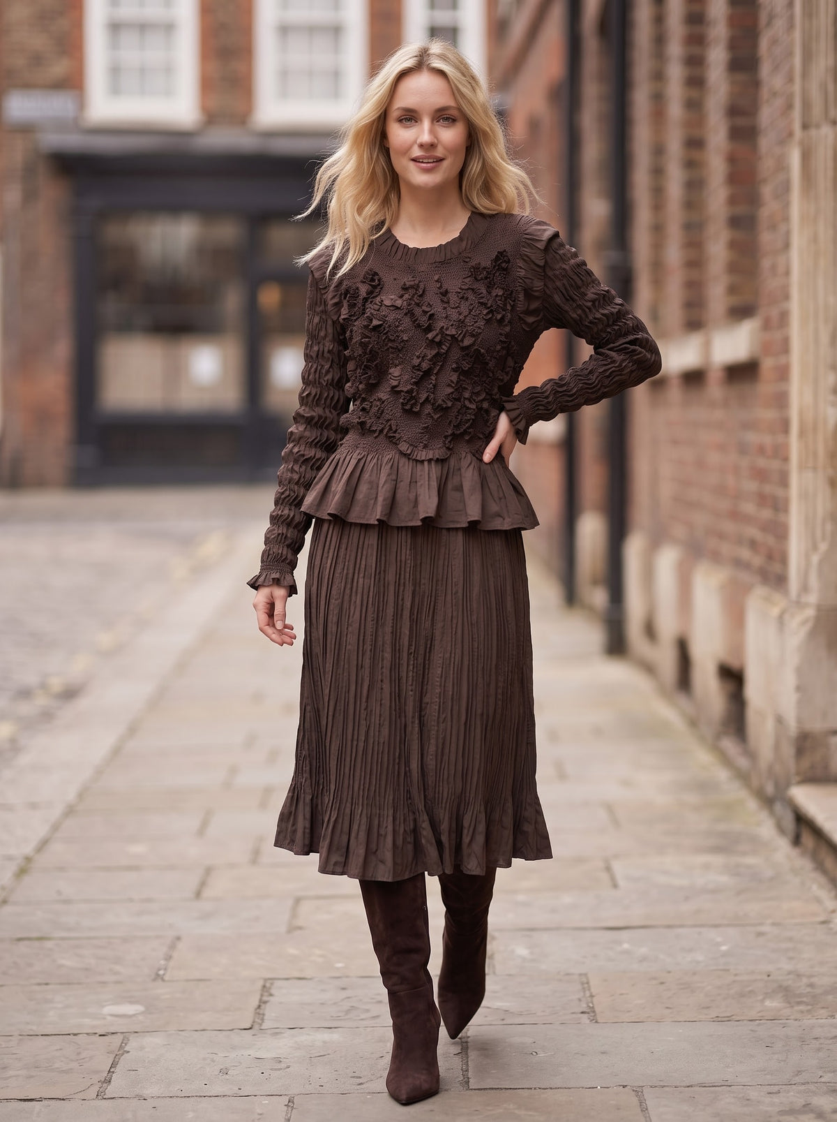 Front view of a model wearing Emma chocolate Confetti Top and matching crinkle skirt with brown boots.